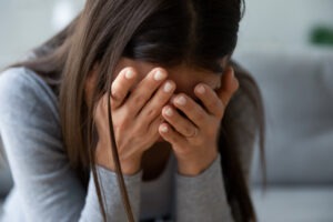 woman with head in her hands crying after wrongful death