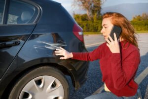 woman calling insurance service after car crash