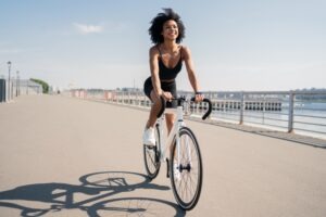 woman on bicycle on boardwalk