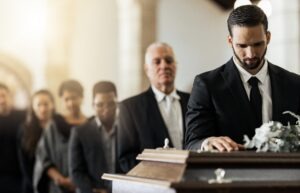 line of mourners at coffin