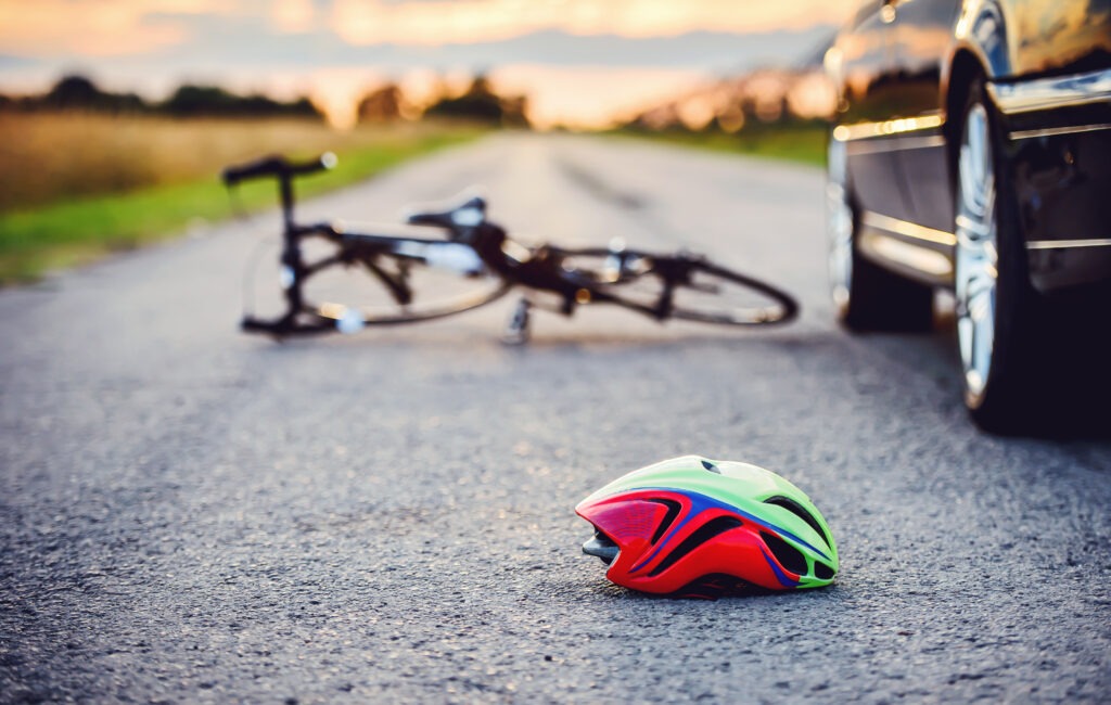 traffic accident with bicycle helmet on road